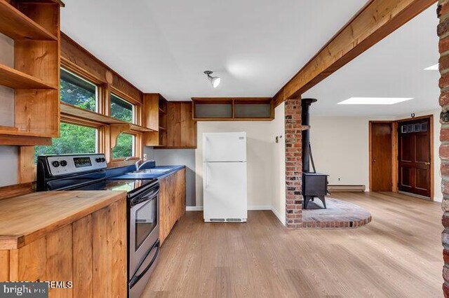 305 Nautilus Blvd, Forked River, NJ 08731 - kitchen featuring freestanding refrigerator, electric stove, a wood stove, open shelves, and light wood-type flooring