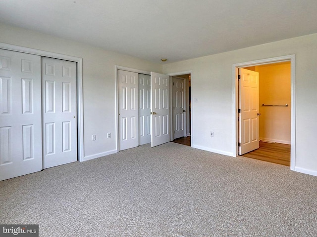 105 Sailor Ln, Milton, DE 19968 - unfurnished bedroom featuring carpet, baseboards, two closets, and connected bathroom