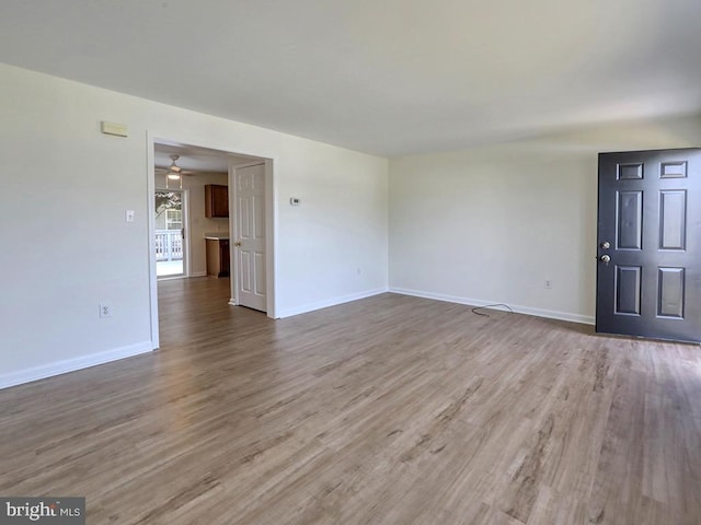 105 Sailor Ln, Milton, DE 19968 - unfurnished living room with wood finished floors, baseboards, and ceiling fan
