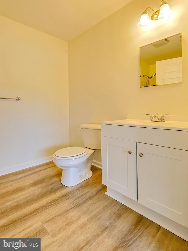 105 Sailor Ln, Milton, DE 19968 - bathroom featuring wood finished floors, toilet, baseboards, and vanity