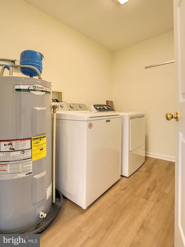 105 Sailor Ln, Milton, DE 19968 - laundry room with electric water heater, light wood-type flooring, and washer and clothes dryer