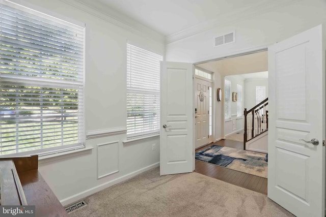 7571 Kindler Overlook Dr, Laurel, MD 20723 - carpeted entryway with ornamental molding, wainscoting, and stairway