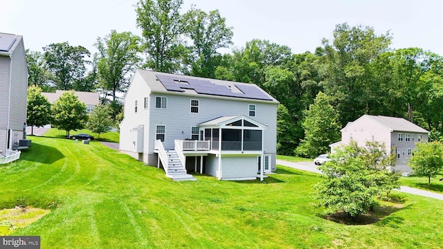 7571 Kindler Overlook Dr, Laurel, MD 20723 - back of property featuring stairway, roof mounted solar panels, a yard, and a wooden deck