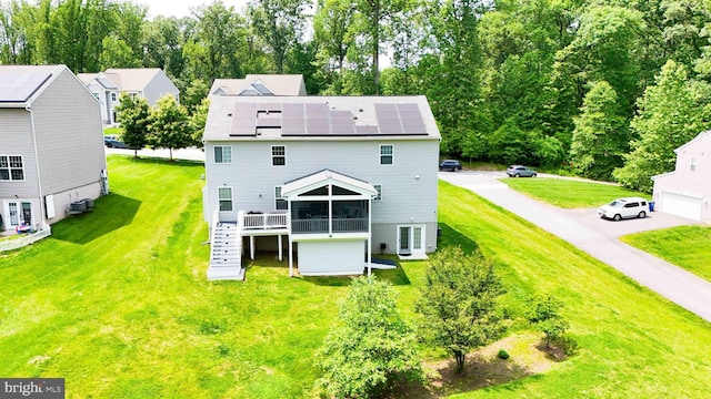 7571 Kindler Overlook Dr, Laurel, MD 20723 - rear view of property with roof mounted solar panels, a sunroom, and a yard