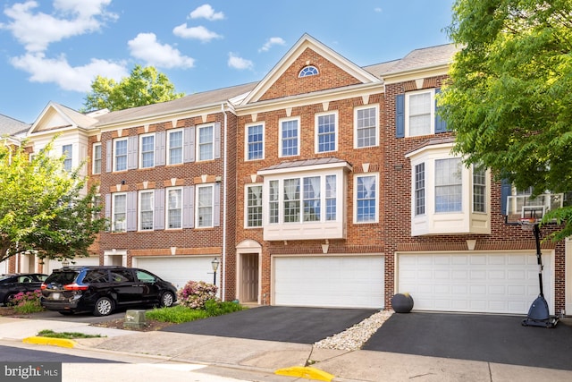 view of front of property with driveway, brick siding, and an attached garage