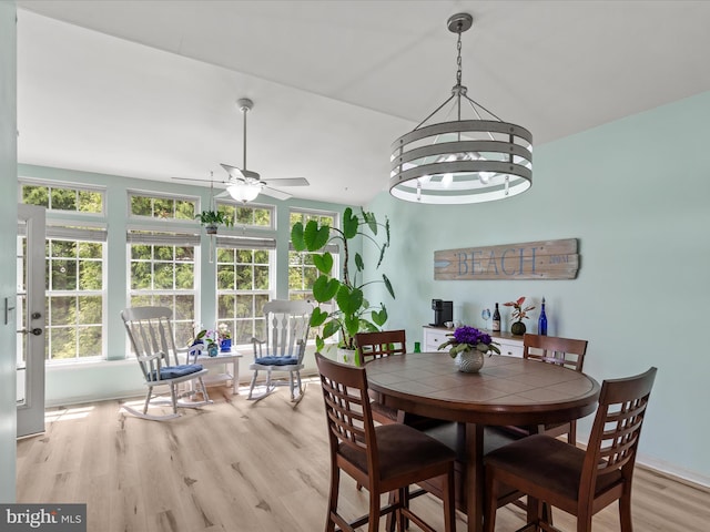 dining room with light wood-style flooring, ceiling fan, and vaulted ceiling