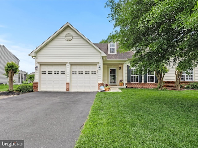 view of front of property featuring driveway, an attached garage, a front yard, and brick siding