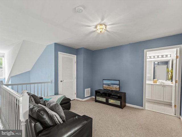 living area featuring light colored carpet and baseboards