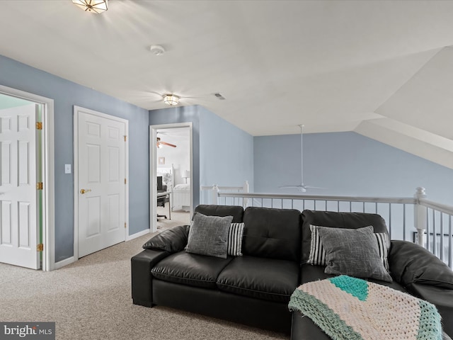 living area with ceiling fan, carpet, and baseboards