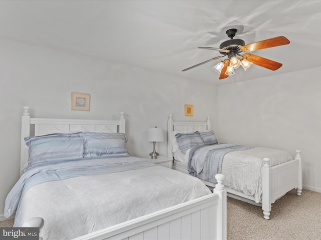 carpeted bedroom with ceiling fan and baseboards