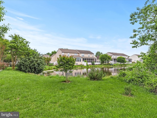 view of yard featuring a water view and a residential view