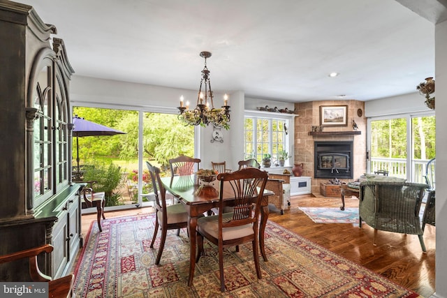 13928 Green Branch Dr, Phoenix, MD 21131 - dining room featuring plenty of natural light, a chandelier, wood finished floors, a large fireplace, and recessed lighting