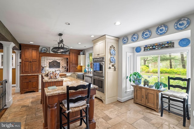 13928 Green Branch Dr, Phoenix, MD 21131 - kitchen featuring stone tile floors, an island with sink, stainless steel appliances, recessed lighting, and light stone counters