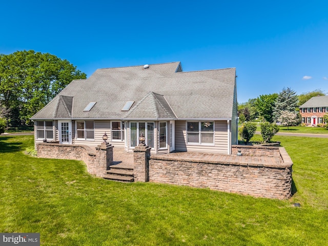 106 Girard Ave, Hatboro, PA 19040 - back of property featuring a sunroom, a lawn, roof with shingles, and a patio area