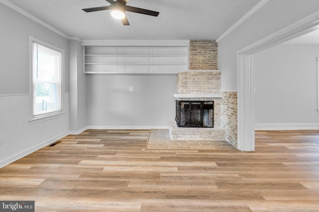 700 Strahle St, Philadelphia, PA 19111 - unfurnished living room featuring ceiling fan, a brick fireplace, wood finished floors, and crown molding