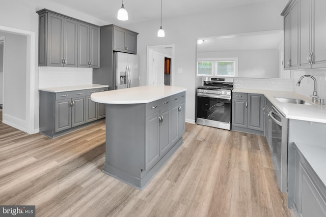 700 Strahle St, Philadelphia, PA 19111 - kitchen with gray cabinetry, appliances with stainless steel finishes, a sink, and backsplash