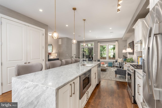 3811 New Hampshire Ave NW Unit 1, Washington, DC 20011 - kitchen with appliances with stainless steel finishes, open floor plan, white cabinetry, dark wood finished floors, and recessed lighting