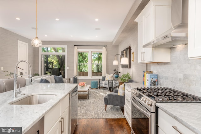 3811 New Hampshire Ave NW Unit 1, Washington, DC 20011 - kitchen with stainless steel appliances, wall chimney range hood, open floor plan, dark wood-type flooring, and white cabinets
