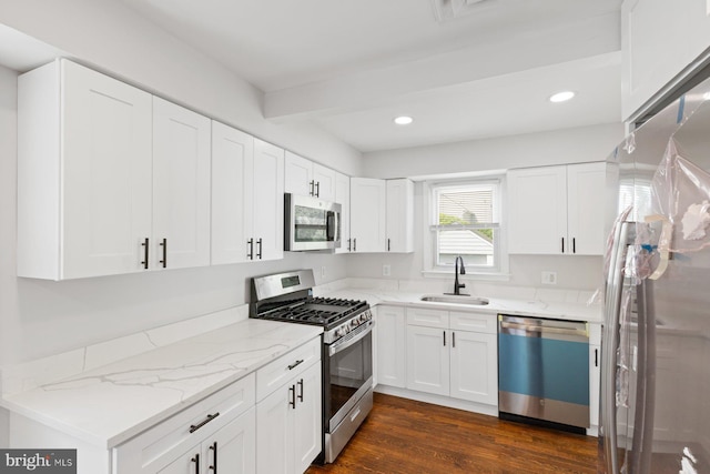 9606 Oak Summit Ave, Baltimore, MD 21234 - kitchen featuring stainless steel appliances, a sink, light stone countertops, dark wood-style floors, and recessed lighting
