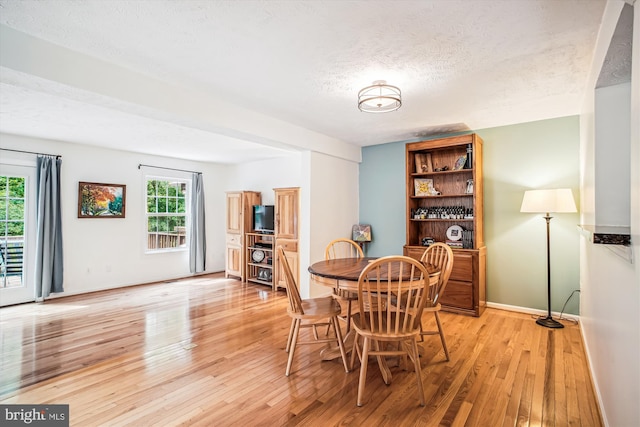 1559 Autumn Ridge Cir, Reston, VA 20194 - dining room with light wood-style flooring, a textured ceiling, and baseboards