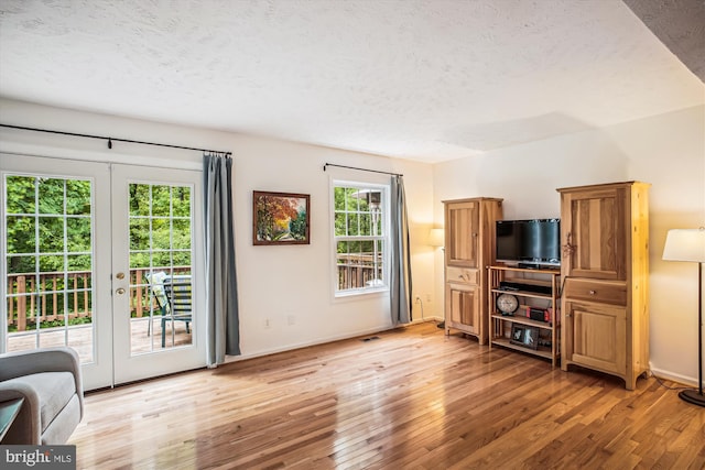 1559 Autumn Ridge Cir, Reston, VA 20194 - living area with french doors, a textured ceiling, light wood-style floors, and baseboards