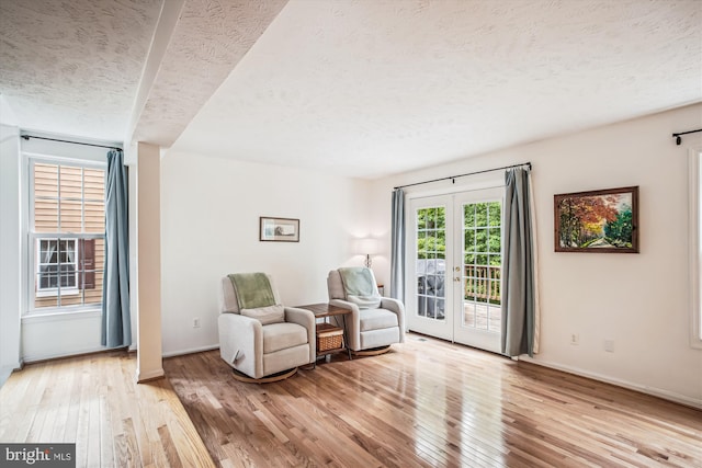 1559 Autumn Ridge Cir, Reston, VA 20194 - sitting room featuring a textured ceiling, light wood finished floors, french doors, and baseboards