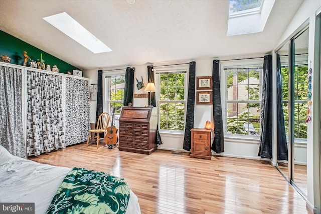 1559 Autumn Ridge Cir, Reston, VA 20194 - bedroom featuring a skylight, lofted ceiling, wood finished floors, and baseboards