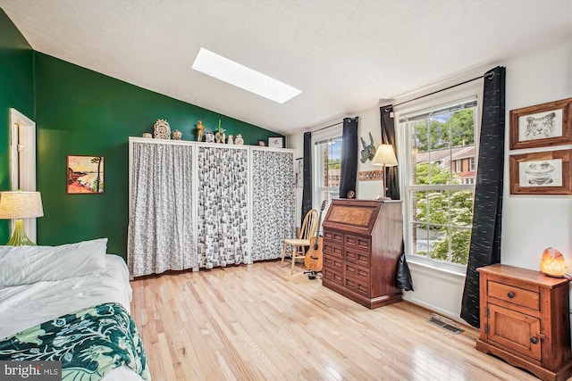 1559 Autumn Ridge Cir, Reston, VA 20194 - bedroom featuring vaulted ceiling, a skylight, and wood finished floors