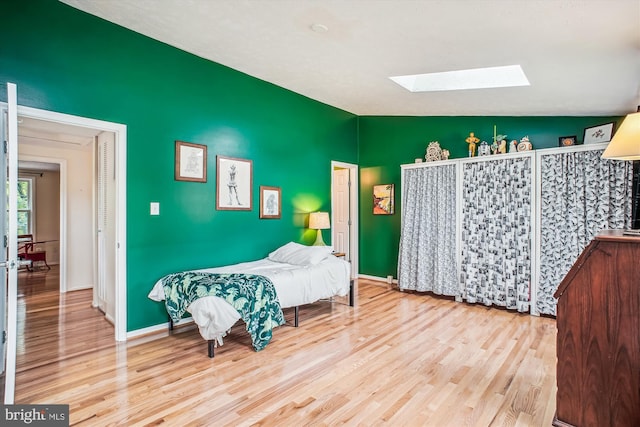 1559 Autumn Ridge Cir, Reston, VA 20194 - bedroom with a skylight, wood finished floors, baseboards, and vaulted ceiling