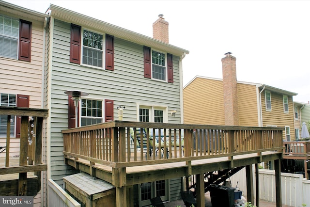 1559 Autumn Ridge Cir, Reston, VA 20194 - rear view of house with a wooden deck and a chimney