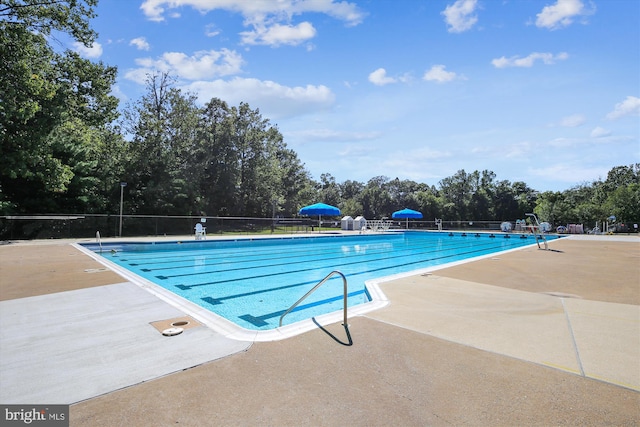 1559 Autumn Ridge Cir, Reston, VA 20194 - community pool with fence, a patio area, and view of scattered trees