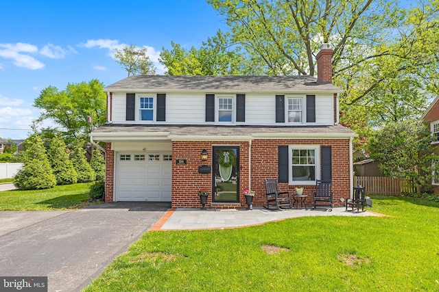 106 Debaran Ln, Bryn Mawr, PA 19010 - view of front of property featuring a chimney, an attached garage, brick siding, and asphalt driveway