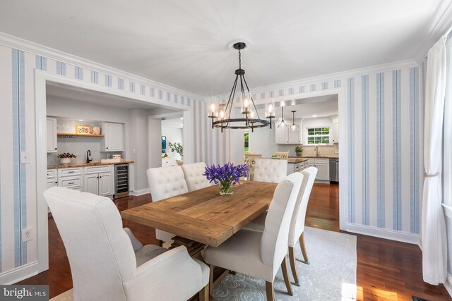 106 Debaran Ln, Bryn Mawr, PA 19010 - dining area featuring wine cooler, a chandelier, dark wood-style flooring, wallpapered walls, and baseboards