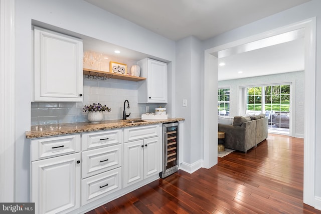 106 Debaran Ln, Bryn Mawr, PA 19010 - indoor wet bar with beverage cooler, decorative backsplash, dark wood finished floors, baseboards, and recessed lighting