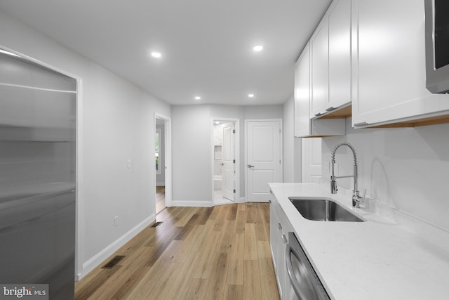 6005 Reed St, Landover, MD 20785 - kitchen with a sink, appliances with stainless steel finishes, white cabinets, recessed lighting, and light wood-style flooring