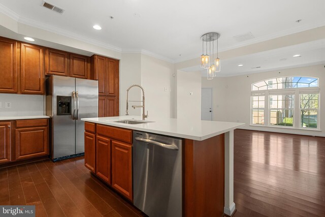 21552 Romans Dr, Ashburn, VA 20147 - kitchen with stainless steel appliances, a sink, brown cabinets, dark wood-type flooring, and crown molding
