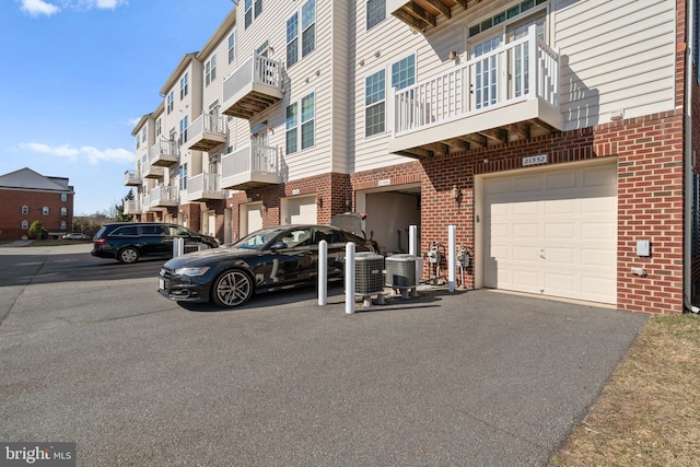 21552 Romans Dr, Ashburn, VA 20147 - view of building exterior featuring a garage and asphalt driveway