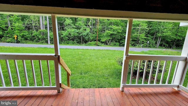 wooden deck featuring a yard