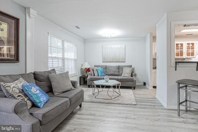 living room with light wood-style floors and baseboards