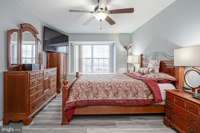 bedroom with multiple windows, light wood-type flooring, and a ceiling fan