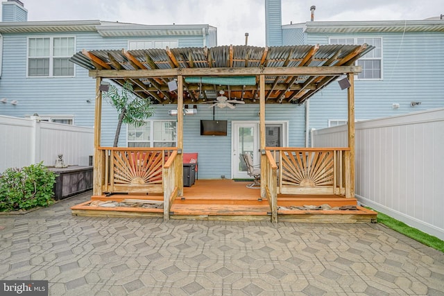 view of patio / terrace with ceiling fan, a wooden deck, and fence