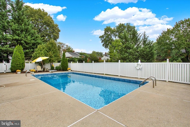 view of pool featuring a patio and fence