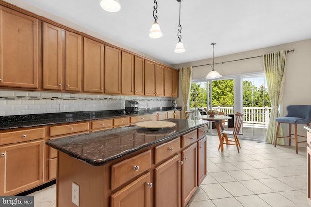 217 Liberty Trail Ct W, Fountainville, PA 18923 - kitchen with a kitchen island, pendant lighting, brown cabinetry, decorative backsplash, and light tile patterned floors