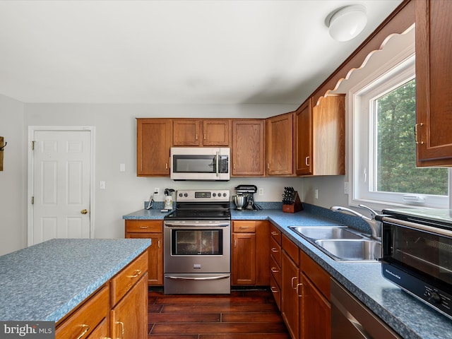 325 Chandler Dr, Shepherdstown, WV 25443 - kitchen with stainless steel appliances, dark wood finished floors, a sink, and brown cabinets