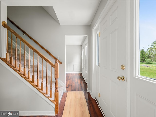 325 Chandler Dr, Shepherdstown, WV 25443 - entryway featuring dark wood finished floors, wainscoting, stairway, and a decorative wall