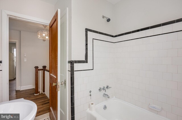 3010 Woodring Ave, Baltimore, MD 21234 - full bath featuring wood finished floors, shower / tub combination, and baseboards