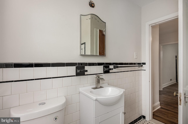3010 Woodring Ave, Baltimore, MD 21234 - bathroom with tile walls, vanity, toilet, and wainscoting