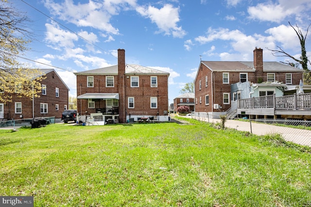 3010 Woodring Ave, Baltimore, MD 21234 - back of property featuring a yard, a chimney, a deck, brick siding, and a residential view