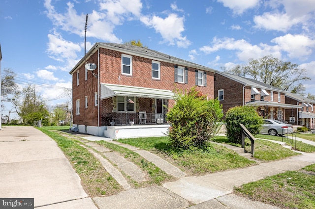 3010 Woodring Ave, Baltimore, MD 21234 - townhome / multi-family property with brick siding and a porch