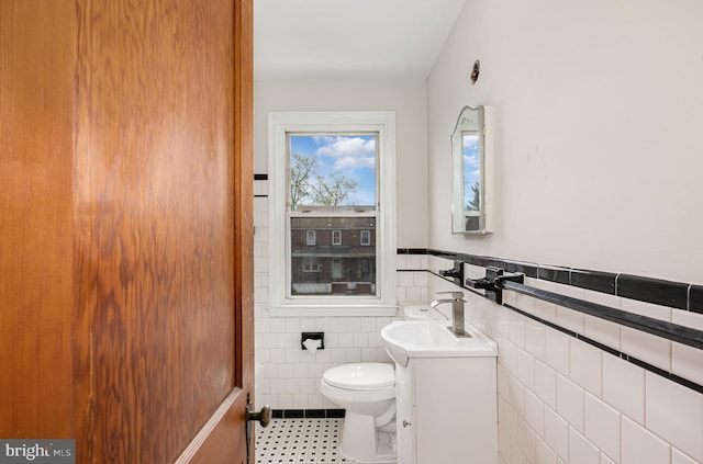 3010 Woodring Ave, Baltimore, MD 21234 - bathroom with tile walls, toilet, tile patterned floors, vanity, and wainscoting